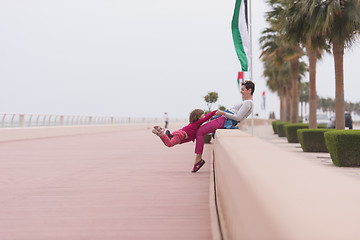 Image showing mother and cute little girl on the promenade by the sea