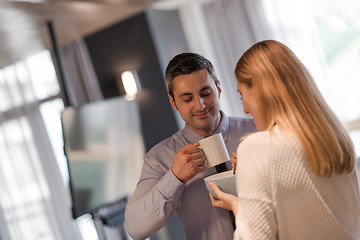 Image showing A young couple is preparing for a job and using a laptop