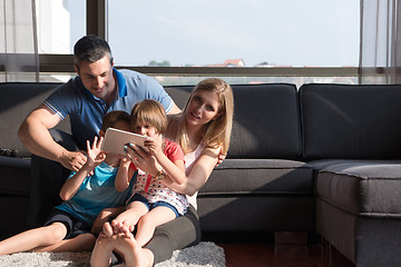 Image showing happy young couple spending time with kids