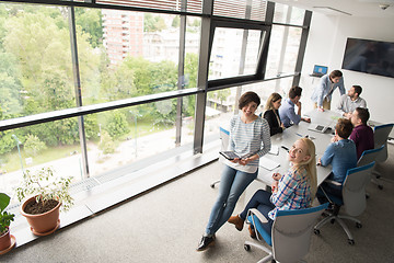 Image showing Pretty Businesswomen Using Tablet In Office Building during conf