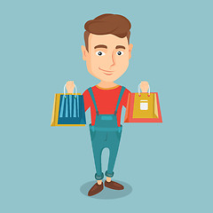 Image showing Happy man holding shopping bags.