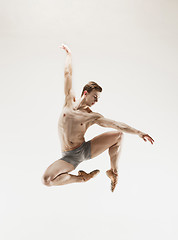 Image showing The male athletic ballet dancer performing dance isolated on white background.