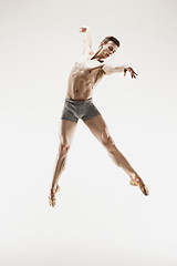 Image showing The male athletic ballet dancer performing dance isolated on white background.