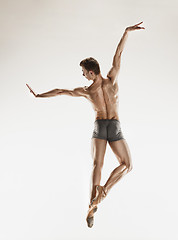 Image showing The male athletic ballet dancer performing dance isolated on white background.