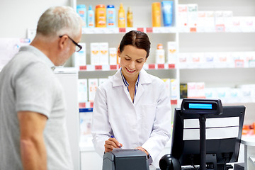 Image showing apothecary and senior customer at pharmacy