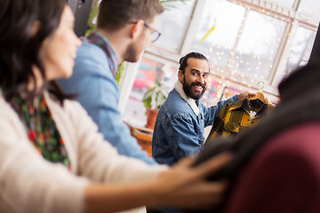 Image showing friends choosing clothes at vintage clothing store