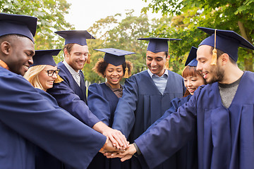 Image showing happy students or bachelors in mortar boards