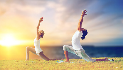 Image showing couple making yoga low lunge pose outdoors