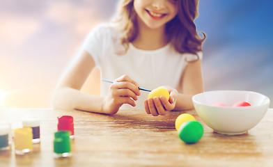 Image showing close up of girl coloring easter eggs