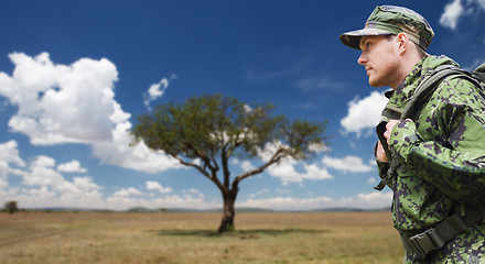 Image showing soldier in military uniform with backpack hiking