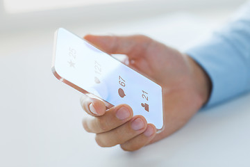 Image showing hand with social media icons on smartphone