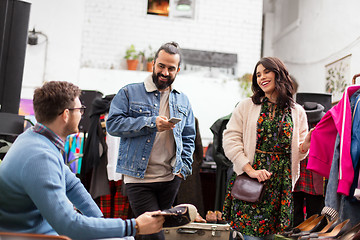 Image showing friends choosing clothes at vintage clothing store