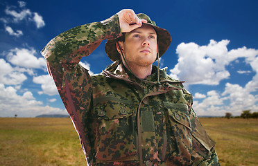 Image showing soldier or traveler in military uniform over sky