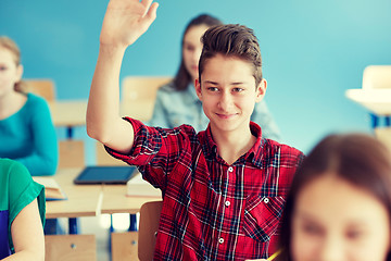 Image showing happy student boy raising hand at school lesson