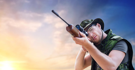 Image showing soldier or hunter with gun aiming or shooting