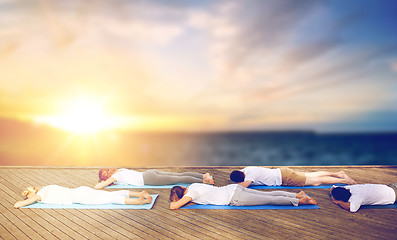 Image showing group of people doing yoga outdoors
