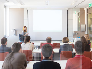 Image showing Woman giving presentation in lecture hall at university.