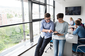 Image showing Two Business People Working With Tablet in office