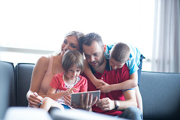 Image showing happy young couple spending time with kids