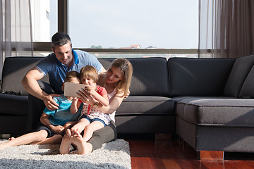 Image showing happy young couple spending time with kids