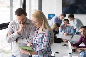 Image showing Two Business People Working With Tablet in office