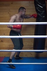 Image showing kick boxer training on a punching bag