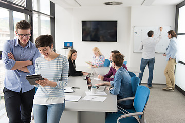 Image showing Two Business People Working With Tablet in office