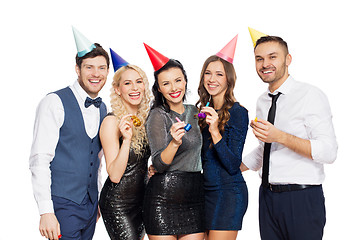 Image showing happy couple with party blowers having fun