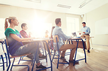 Image showing group of students and teacher with papers or tests