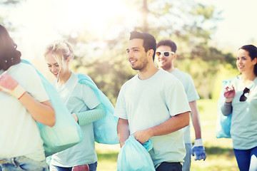 Image showing group of volunteers with garbage bags in park