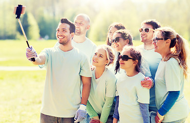 Image showing group of volunteers taking smartphone selfie