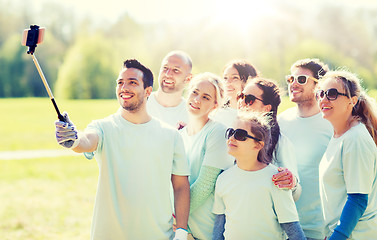 Image showing group of volunteers taking smartphone selfie