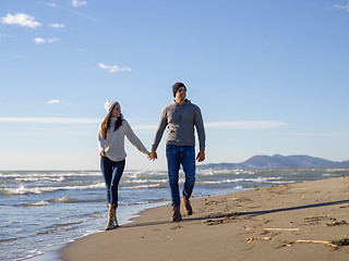 Image showing Loving young couple on a beach at autumn sunny day