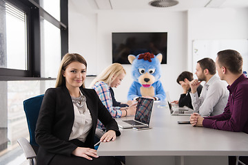 Image showing boss dresed as bear having fun with business people in trendy of