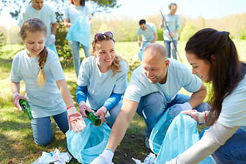 Image showing volunteers with garbage bags cleaning park area