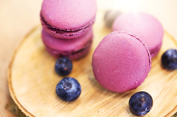 Image showing blueberry macarons on wooden stand