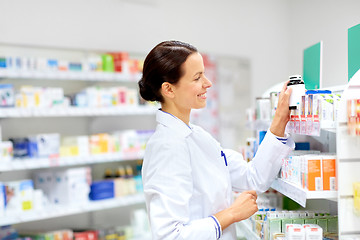 Image showing happy female apothecary with drug at pharmacy