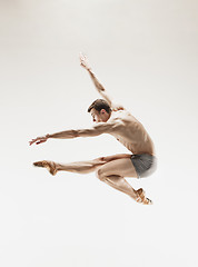 Image showing The male athletic ballet dancer performing dance isolated on white background.