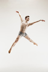 Image showing The male athletic ballet dancer performing dance isolated on white background.