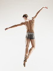 Image showing The male athletic ballet dancer performing dance isolated on white background.