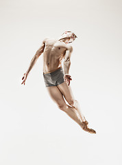 Image showing The male athletic ballet dancer performing dance isolated on white background.