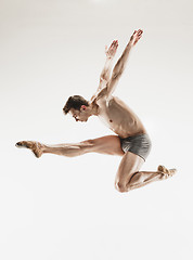 Image showing The male athletic ballet dancer performing dance isolated on white background.