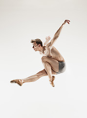 Image showing The male athletic ballet dancer performing dance isolated on white background.