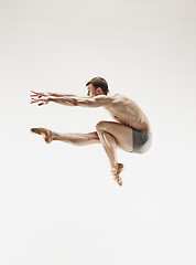 Image showing The male athletic ballet dancer performing dance isolated on white background.