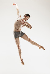 Image showing The male athletic ballet dancer performing dance isolated on white background.