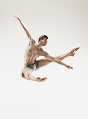 Image showing The male athletic ballet dancer performing dance isolated on white background.