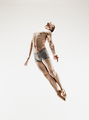 Image showing The male athletic ballet dancer performing dance isolated on white background.