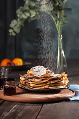 Image showing Fresh homemade french crepes made with eggs, milk and flour, filled with marmalade on a vintage plate