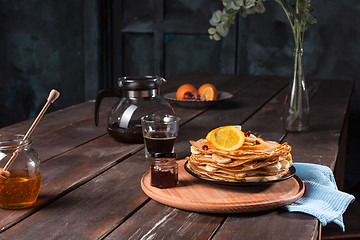 Image showing Fresh homemade french crepes made with eggs, milk and flour, filled with marmalade on a vintage plate