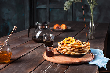 Image showing Fresh homemade french crepes made with eggs, milk and flour, filled with marmalade on a vintage plate